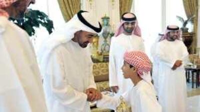 Sheikh Mohammed bin Zayed, Crown Prince of Abu Dhabi and Deputy Supreme Commander of the UAE Armed Forces, receives a member of The Al Ain Culture and Chess Club.