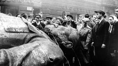 People gather around a fallen statue of Joseph Stalin in front of the National Theater in Budapest, Hungary, on October 24, 1956.