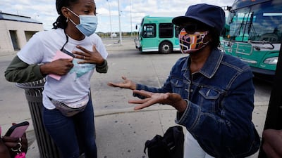 Wendy Caldwell-Liddell, left, who helped start Mobilize Detroit, a newly formed grassroots organization, talks to Margaret Roberts about voting in Detroit, Friday, September 18, 2020. Both President Donald Trump and Democratic presidential nominee Joe Biden are battling for support among Black voters across Michigan. AP Photo