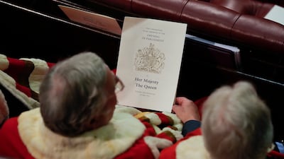Members of the House of Lords hold the program for the queen's speech. Getty Images