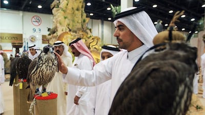 Visitors look at the price tags on the falcons. Ravindranath K / The National