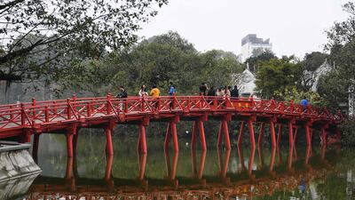 Tourists walk on the Huc Bridge over Hoan Kiem Lake in downtown Hanoi. Vietnam was ranked seventh in the survey. AFP