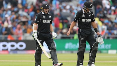 New Zealand's Ross Taylor, right, and Tom Latham leave the field after rain stopped play in the Cricket World Cup semi-final with India. The match will restart on Wednesday. AP Photo