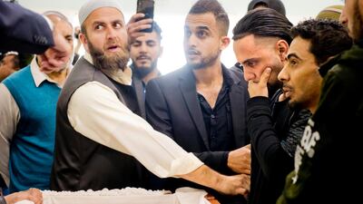 Ali Hassan, second from right, views the wrapped body of his two-year-old son, Abdullah Hassan, at his funeral at the Sacramento Islamic Center on Saturday. AP