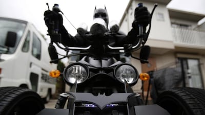 Chibatman sits on his Chibatpod, designed from inspiration of the Batpod from the movies The Dark Knight and The Dark Knight Rises, delivering smiles instead of fighting crime.