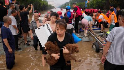 Residents evacuate their homes after flooding in Zhuozhou in northern China's Hebei province, south of Beijing, on Wednesday. AP Photo