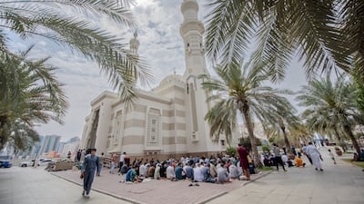 Worshippers gather for Friday prayers at Al Qasba mosque in Sharjah. Ahmed Ramzan / The National