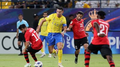 Al Nassr's Cristiano Ronaldo in action with FC Istiklol's Ehson Panshanbe and Aliser Dzhalilov. Reuters
