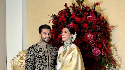 While the couple wore bold red designs at their Italian wedding, they opted for refined gold, black and green for their Indian party.