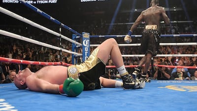 Tyson Fury lies on the canvas after being knocked down by Deontay Wilder during the 12th round. AP Photo