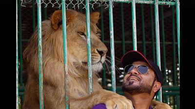 Jasim Al Azur poses next to his Lion at his private zoo in Ras Al khaimah. Satish Kumar / The National