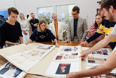Marchetti discusses mood boards with the project's Italian students in Milan. Courtesy YNAP