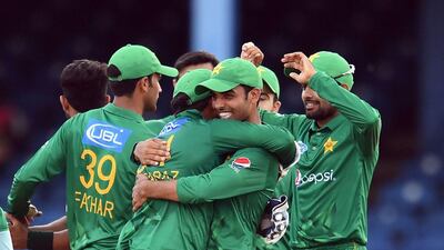 Pakistan's Shadab Khan, right, embraces team captain Sarfraz Ahmed during their Twenty20 match against West Indies on March 30, 2017. Jewel Samad / AFP