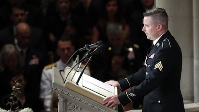 Jimmy McCain reads the poem “The Requiem,” at a memorial service for his father at Washington National Cathedral. AP