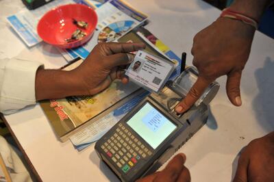 An Indian customer gives a thumb impression to withdraw money from his bank account in Hyderabad. AFP