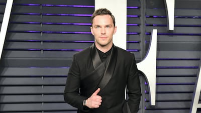 2019: Nicholas Hoult wears a wrap jacket with a side train with a side train by Dior Homme at the 91st Annual Academy Awards on February 24, 2019. BFA