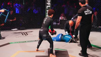 Hattan Al Saif watches on as medics attend to her opponent.