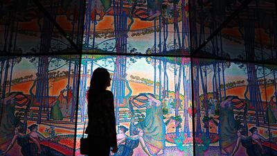 A visitor at an exhibition at the Louvre Abu Dhabi on post Impressionism. Two memorable French projects built in partnership with the Emirates, include the museum, Louvre Abu Dhabi, and the Sorbonne University Abu Dhabi, Chris Whiteoak / The National