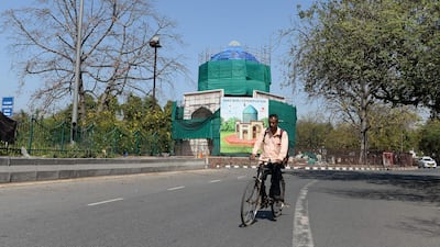 A man cycles along a deserted road in New Delhi. AFP