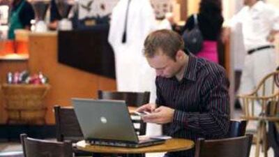 A browser logs on at an Abu Dhabi internet cafe: changes to web addresses could result in string of Hindi characters separated by dots, or a link to a site such as "thenational.newspaper".