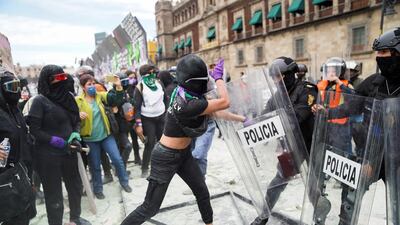 A woman clashes with police officers during a protest outside the National Palace to mark International Women's Day in Mexico City, Mexico. Reuters