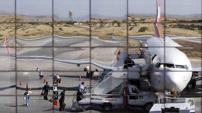 Passengers are reflected in the departure terminal of Nicosia's airport as they board a Turkish Airlines flight.