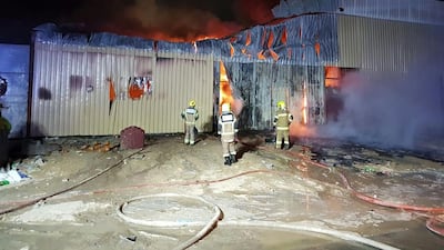 Ajman Civil Defence tackle the fire at a warehouse in the industrial area. Courtesy Ajman Civil Defence