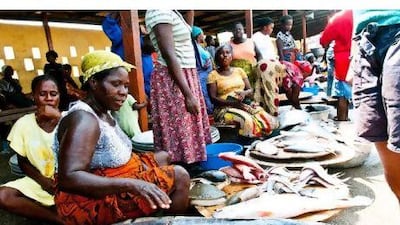 Women sell the day's catch in the fishing harbour in Elmina.