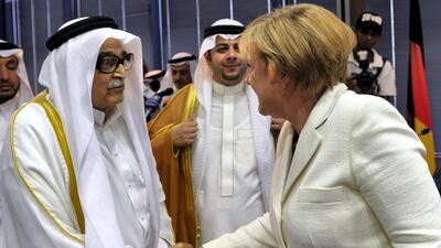 German Chancellor Angela Merkel shakes hands with Saleh Kamel at his office on May 26, 2010, in the Red Sea port city of Jeddah. AFP