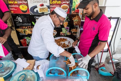 Workers refil containers with freshly fried pakora at Bait Al Shay cafeteria in Al Quoz. Antonie Robertson / The National
