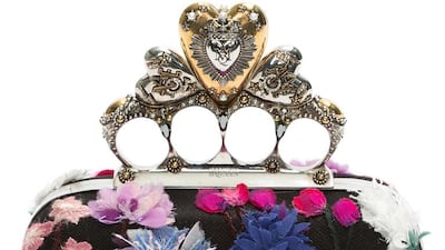 Alexander McQueen’s exquisitely aggressive knuckle-duster clutch is softened with hand-cut, fraying flowers. Courtesy Alexander McQueen.