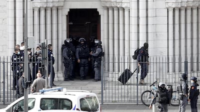 French police officers stand at the entrance of the Notre Dame church. EPA