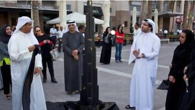 Mohamed Alabbar, founding member and Chairman of Emaar Properties (left) and Tariq Al Gurg, CEO of Dubai Cares (right) unveil the artwork of Emirati artist, Maryam Al Sayegh, as part of the the Burj of Giving auction in benefit of Dubai Cares. Twenty-one artistically adorned Burj Khalifa scale models were auctioned off to raise funds for developing nations. Antonie Robertson / The National