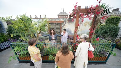 Designer Martha Krempel discusses her Arcadia balcony garden with visitors. PA