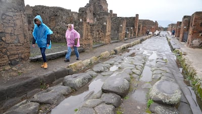 Tourists walk inside the Pompeii site.