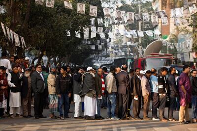 Bangladeshis line up to cast their votes outside a polling station in Dhaka. AP