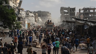Palestinians gather around lorries carrying aid supplies that arrived in Khan Younis in the southern Gaza Strip on October 11. EPA