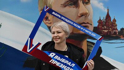A woman poses with a frame that reads 'I have chosen the president', after voting in the Russian-controlled Donetsk region of eastern Ukraine. AP