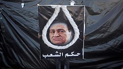 Though little of substance has yet been said at Hosni Mubarak's trial, feelings about the former leader were clear at a rally in Tahrir Square in Cairo on Friday where this placard in Arabic read "rule of the people".