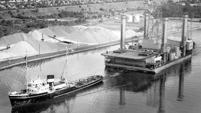 The Adma Enterprise is towed along the Kiel Canal in northern Germany in 1957, at the start of its journey to Abu Dhabi. Photo: BP Archives