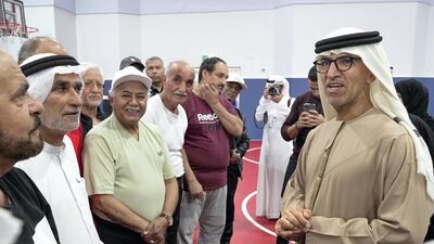 Dr. Mugheer Khamis Al Khaili, Chairman of the Department of Community Development talks to senior fitness enthusiasts after a workout session. Victor Besa / The National
