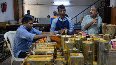 Visually impaired workers make candles in a workshop of the Blind School Relief Association in New Delhi on October 16, 2019. The association sells candles, oil lamps and paper products made by visually impaired trainees and workers ahead of Hindu festival 'Diwali,' or the festival of light. AFP / Sajjad Hussain