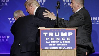 Members of the secret service usher Republican presidential candidate Donald Trump off the stage at a campaign rally in Reno, Nevada. John Locher / AP Photo