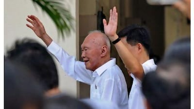 Singapore's founding prime minister, Lee Kuan Yew, waving to his supporters, is to quit the cabinet to make way for younger leaders after the ruling party's worst performance in an election.