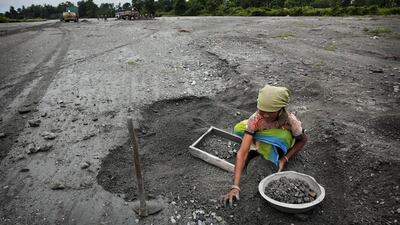 A tea worker sorts out rocks from a dried river bed in Bundapani. The government has launched emergency food and medical relief, but conditions remain grim. Despite the aid, 14 people at Bundapani alone have died in the past eight months, either from malnutrition or inadequate medical care.