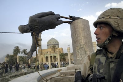 A US soldier watches as a statue of Saddam Hussein is pulled down in Baghdad, April 9, 2003 Goran Tomasevic / Reuters