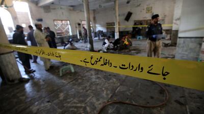 Security officials inspect the scene of an explosion at an Islamic seminary in Peshawar, Pakistan. EPA