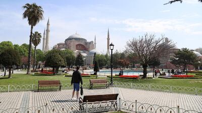 Tourists exempt from the curfew in Turkey walk around Istanbul. Getty Images