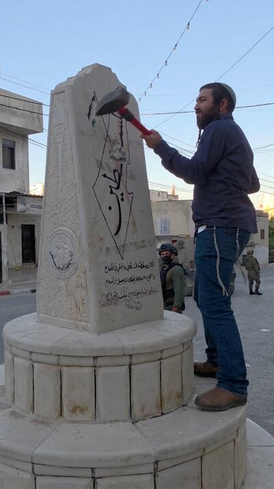 Zvi Sukkot smashes a monument in Madama in the occupied West Bank. Reuters