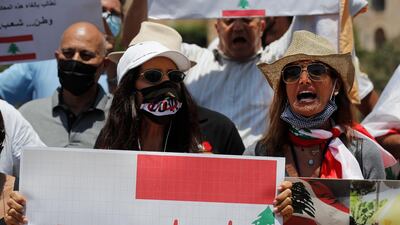 Anti-Hezbollah protesters shout slogans and hold a placard with the UN Resolution 1559, which was adopted in September 2004, that called for disarmament all Lebanese and non-Lebanese militias, during a sit-in against Hezbollah and Iran in front the United Nations headquarters, in Beirut, Lebanon. AP